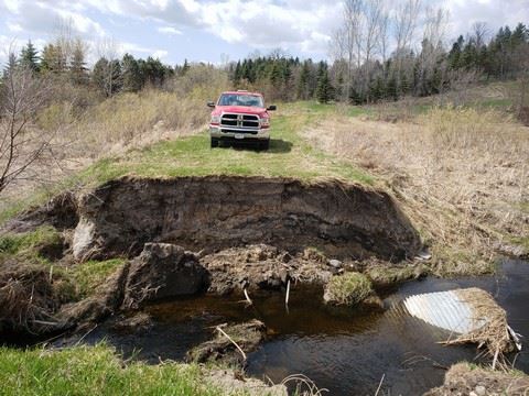 Red Truck by Hole in Ground